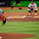 Simone Biles performs a flip while throwing out the ceremonial first pitch prior to Game 2 of the 2019 World Series on October 23, 2019 in Houston, Tx.